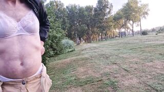 Man wearing lingerie in the park and masturbates in it