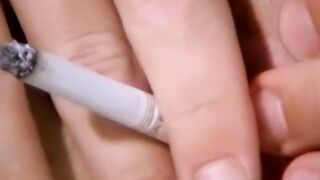 Smoking twink plays with a big butt plug and his fat cock