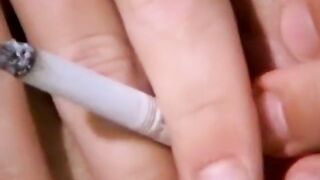 Smoking twink plays with a big butt plug and his fat cock