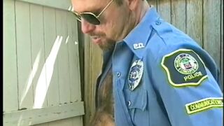 Muscular man in uniform and wearing glasses sucks and blows