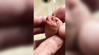 Extreme closeup playing with foreskin and piss, then wanking a string of thick cum into my hand