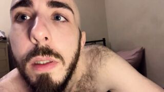 Bald blue-eyed white guy with uncut dick strips down on the bed to reveal very hairy skinny body