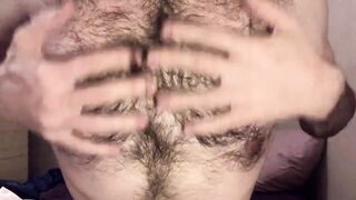 Bald blue-eyed white guy with uncut dick strips down on the bed to reveal very hairy skinny body