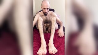 Skinny bearded uncut white guy oiling up my very hairy legs, feet, and ass on the bed