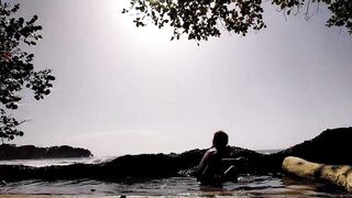 Daring young man enjoys naked in public on the beach