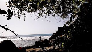 Daring young man enjoys naked in public on the beach