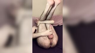 Very hairy skinny blue-eyed white guy jerks off big uncut cock with legs in the air