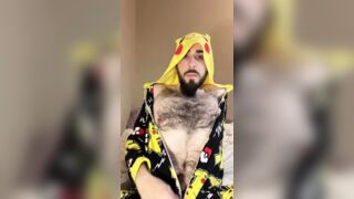 Bald bearded blue-eyed white otter in cute onesie pajamas strips down to tease very hairy ass with a gaming controller