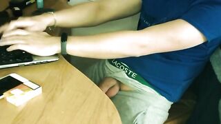 Teen boy jerking off by the desk while working online